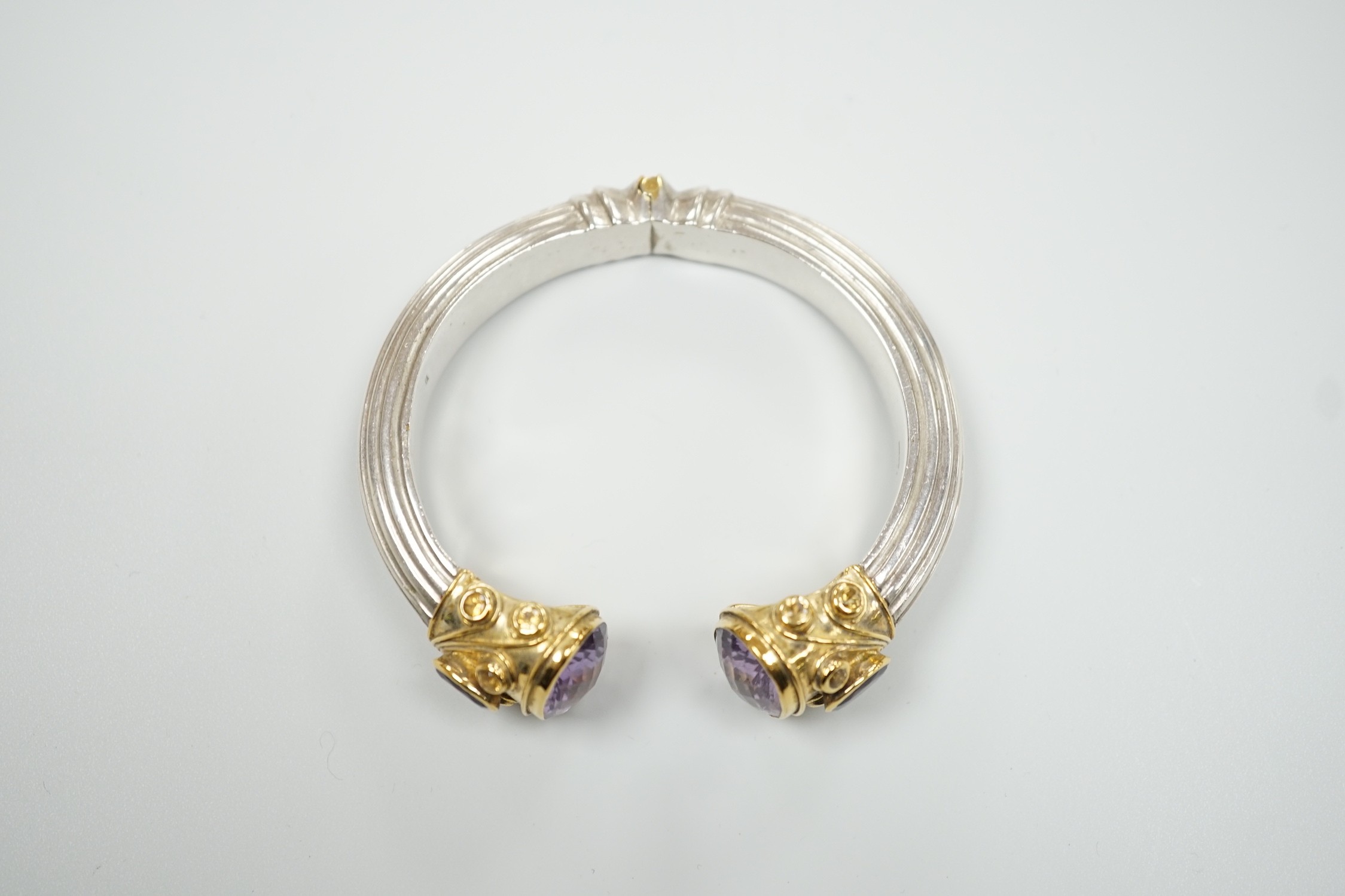 A modern parcel gilt silver amethyst and citrine set openwork spring hinged bangle.